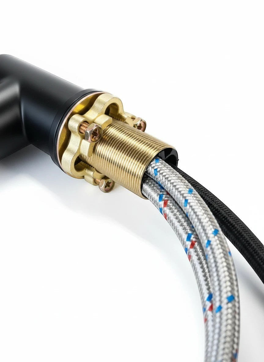 Onyx Elements modern matte black gooseneck kitchen faucet connection with brass fittings and braided hoses.