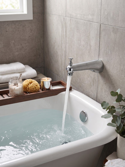 Onyx Elements chrome bathtub spout with diverter filling a white tub in a modern bathroom with spa accessories.