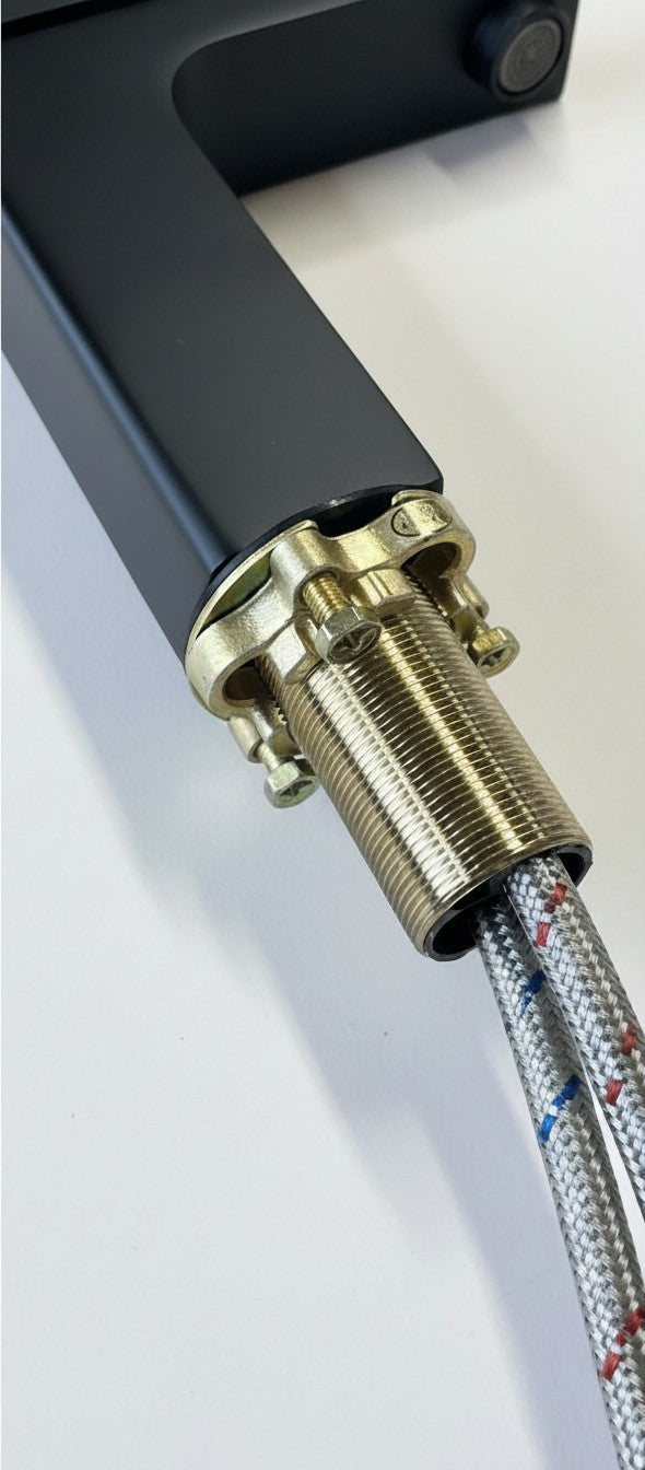 Onyx Elements modern matte black bathroom sink faucet base with threaded mounting hardware and braided supply lines.