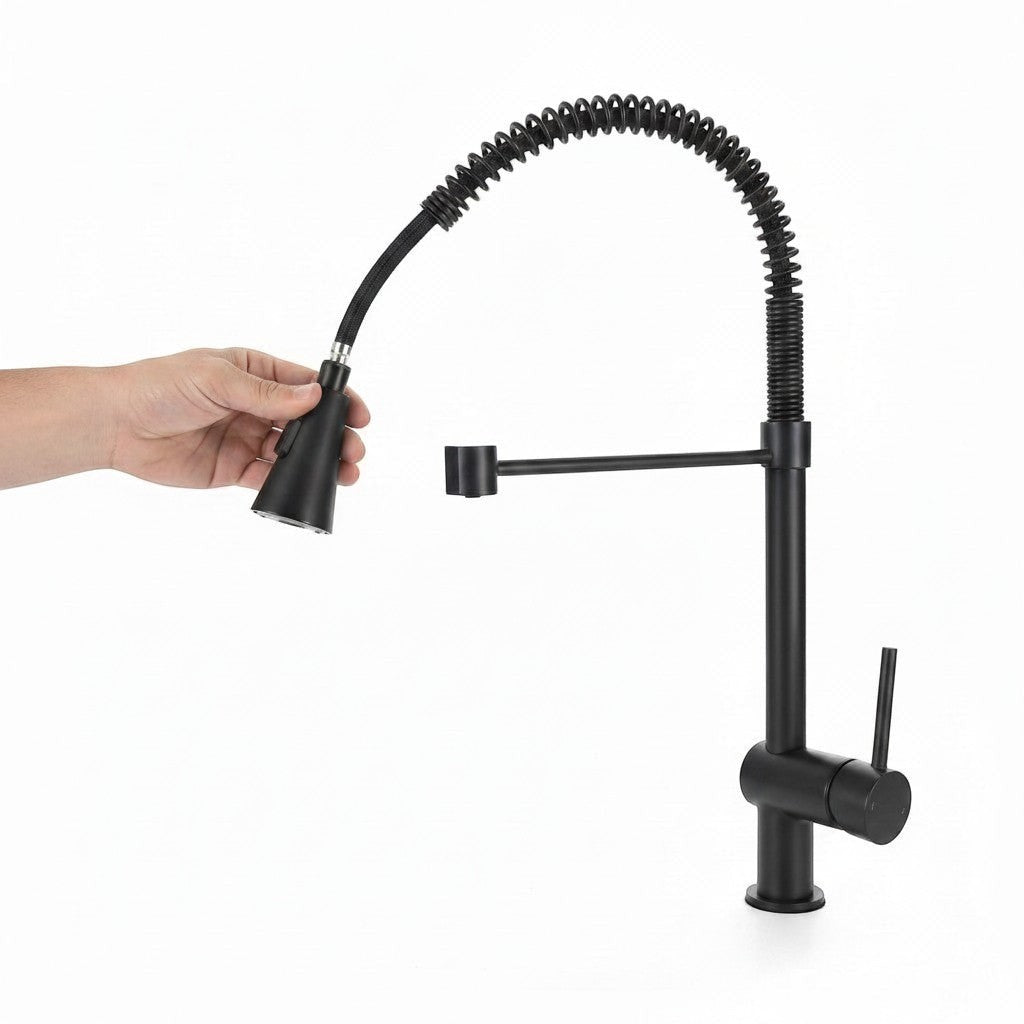 Onyx Elements matte black industrial kitchen faucet with a flexible pull-down sprayer held by a hand.