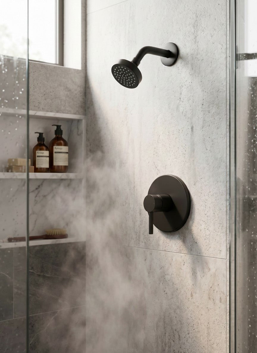 Onyx Elements matte black modern shower faucet and head set installed in a minimalist marble tiled shower.