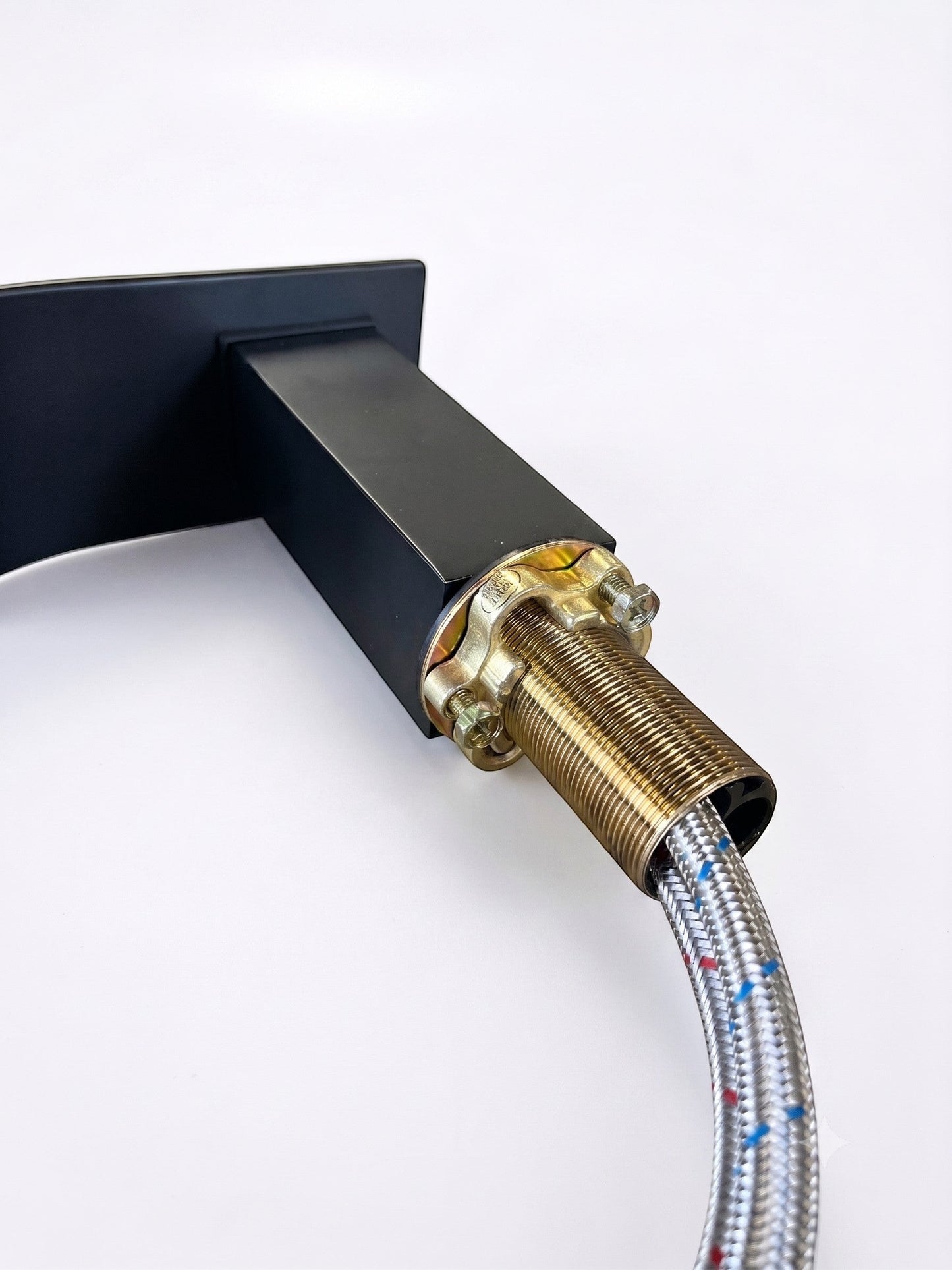 Onyx Elements matte black waterfall bathroom faucet with threaded brass mounting hardware and braided supply line.