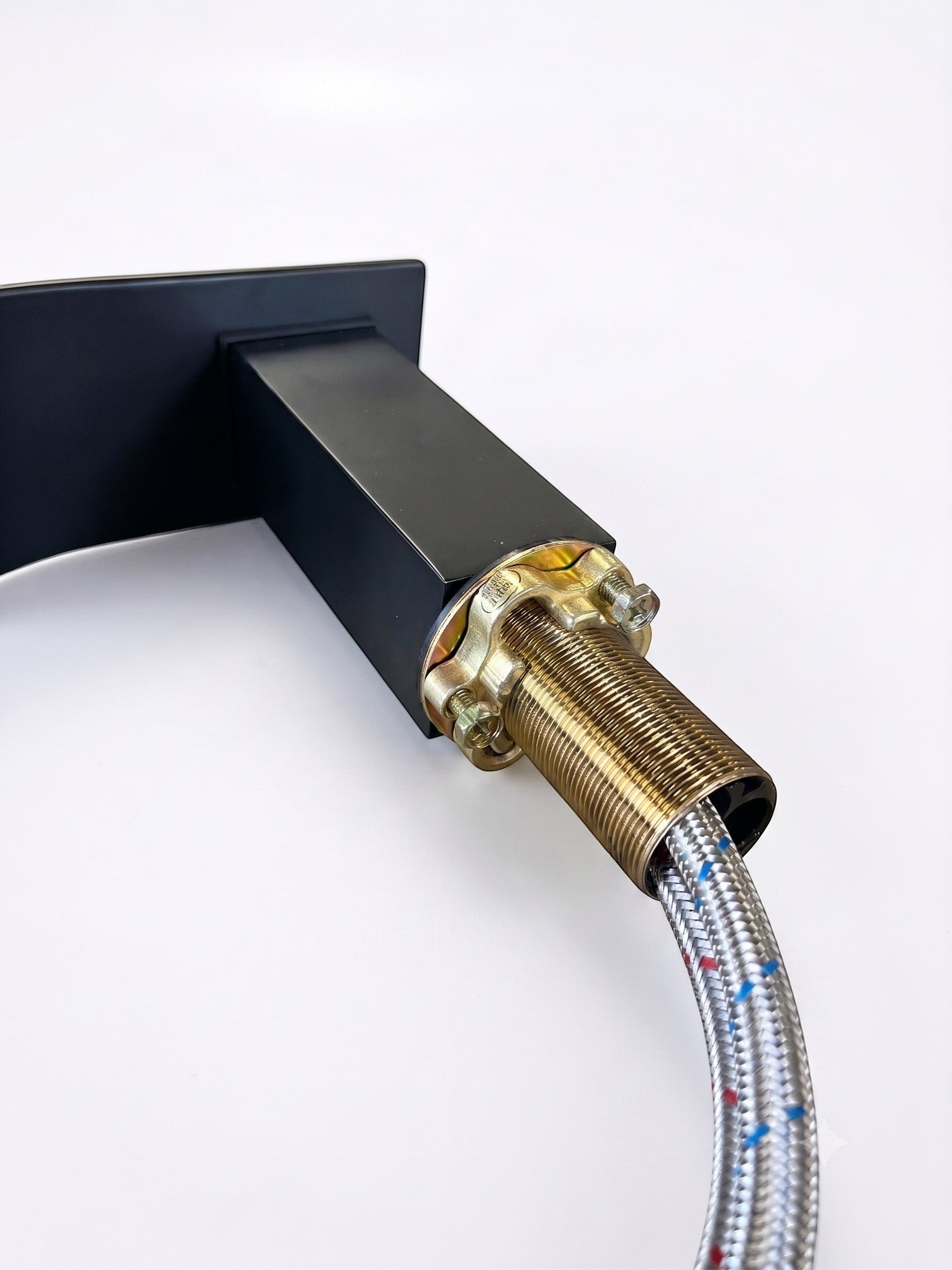 Onyx Elements matte black waterfall bathroom faucet with threaded brass mounting hardware and braided supply line.